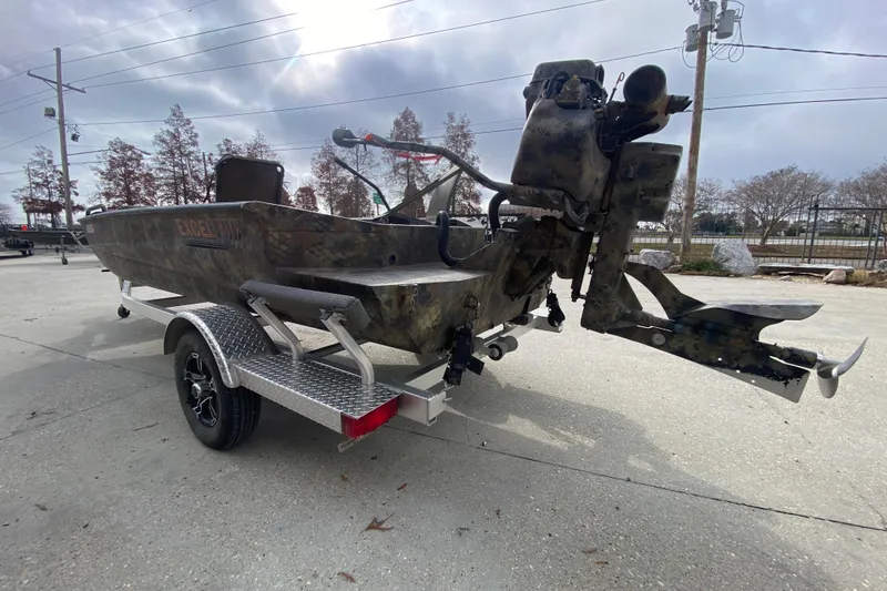 Slide: The Image of 2023 Excel F86 boat on trailer with camouflage design and powerful outboard motor. - 5