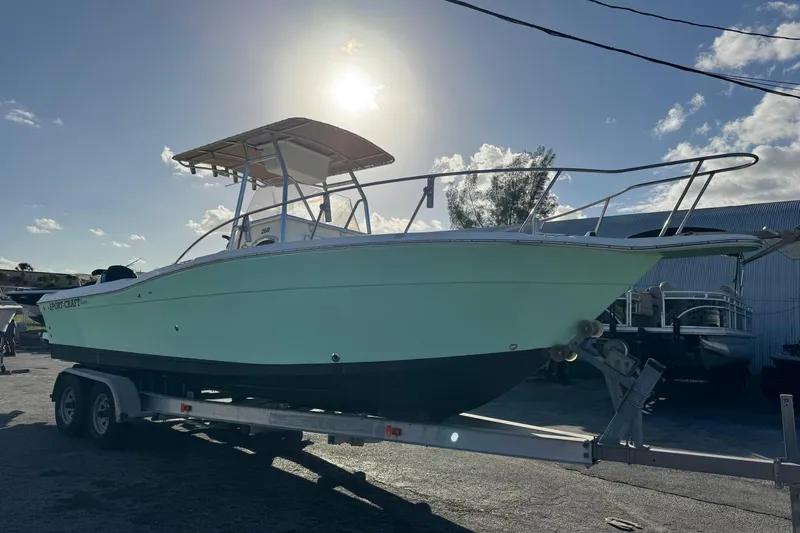The Image of 2001 Sport-Craft 260 Center Console boat on trailer under bright sun. - 0