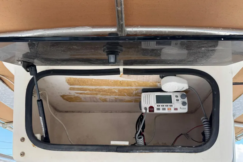 Slide: The Image of 2001 Sport-Craft 260 Center Console radio compartment with installed communication device. - 12
