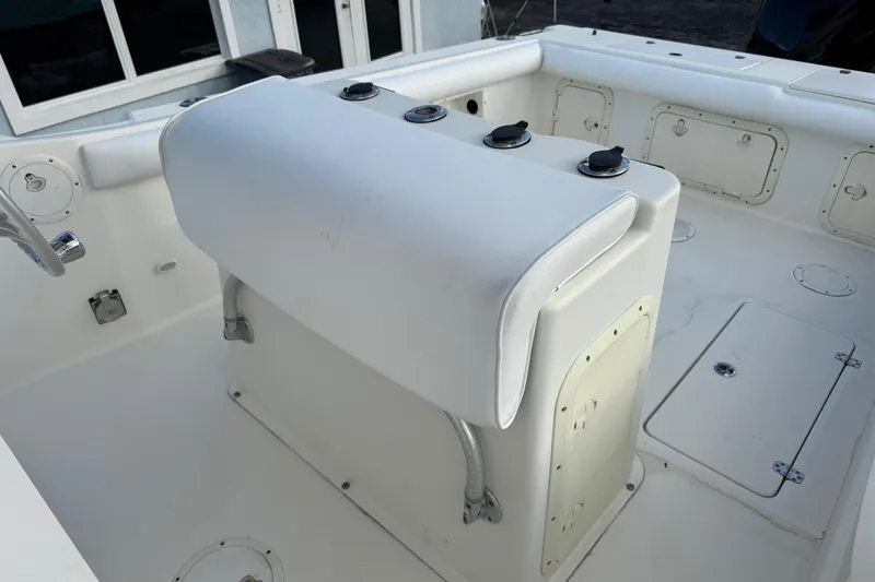 Slide: The Image of 2001 Sport-Craft 260 Center Console boat interior with white seating and storage compartments. - 13