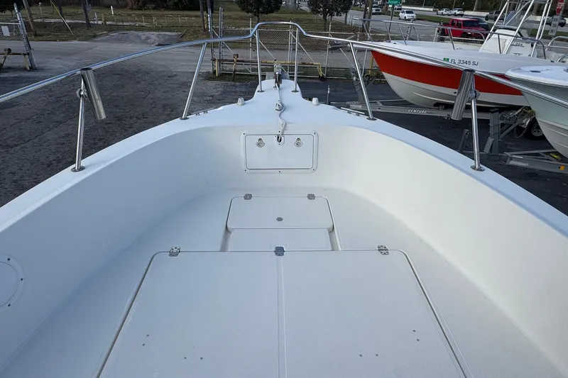 Slide: The Image of 2001 Sport-Craft 260 Center Console boat deck, featuring spacious seating and storage. - 14