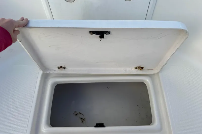 Slide: The Image of Open storage compartment on a 2001 Sport-Craft 260 Center Console boat. - 15