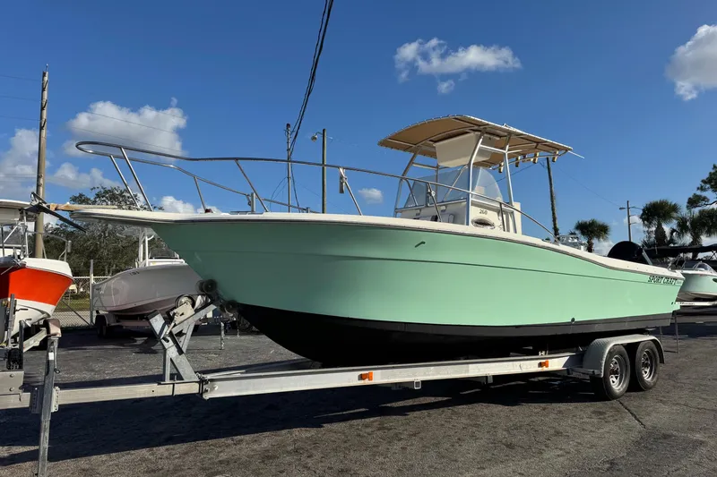 Slide: The Image of 2001 Sport-Craft 260 Center Console boat on trailer under clear blue sky. - 2