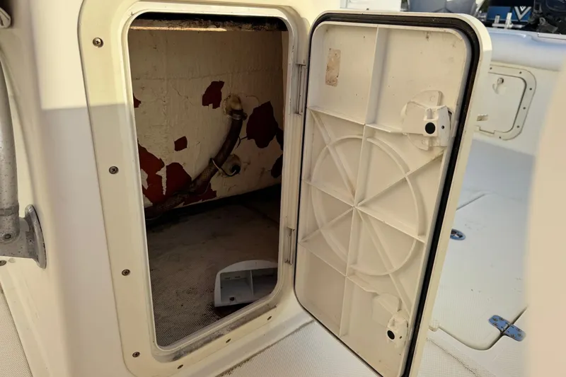 Slide: The Image of Open storage compartment on 2001 Sport-Craft 260 Center Console boat. - 20