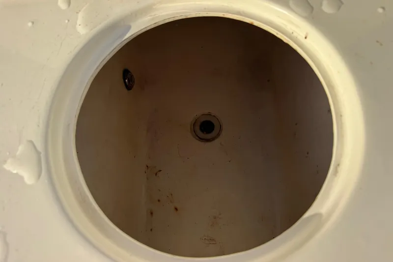 Slide: The Image of Livewell interior of 2001 Sport-Craft 260 Center Console boat, showing drain and water stains. - 22