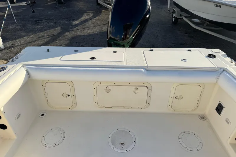 Slide: The Image of 2001 Sport-Craft 260 Center Console boat deck with storage compartments and engine view. - 23