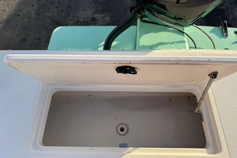 Slide: The Image of Open storage compartment on a 2001 Sport-Craft 260 Center Console boat. - 24