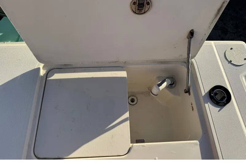 Slide: The Image of Open storage compartment on a 2001 Sport-Craft 260 Center Console boat. - 25