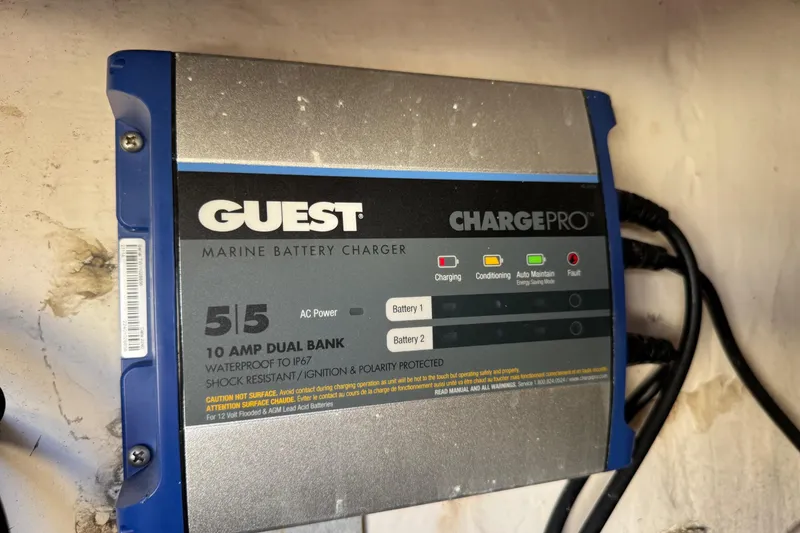 Slide: The Image of Guest marine battery charger, ChargePro model, mounted on a wall, with multiple cables connected. - 29