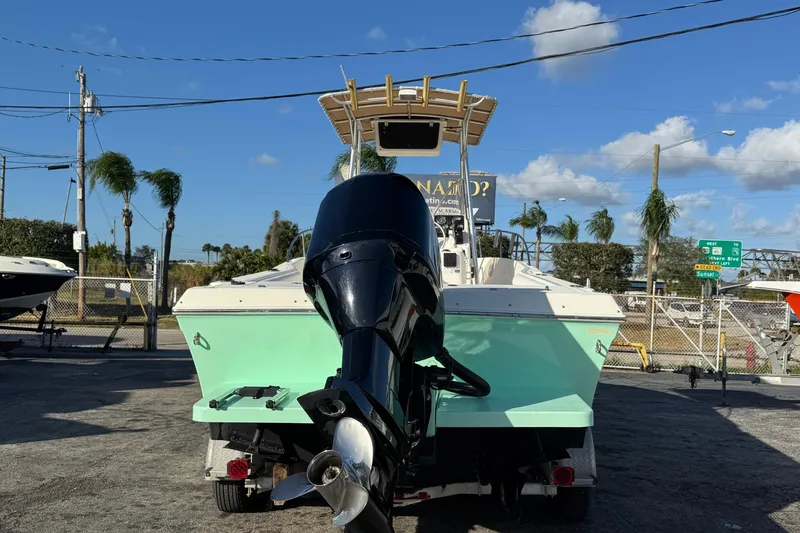 Slide: The Image of 2001 Sport-Craft 260 Center Console boat with outboard motor, parked outdoors. - 3