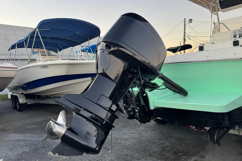 Slide: The Image of 2001 Sport-Craft 260 Center Console boat with outboard motor, parked on a trailer. - 33