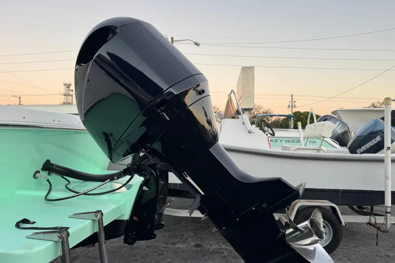 Slide: The Image of 2001 Sport-Craft 260 Center Console boat with powerful outboard motor at sunset. - 34