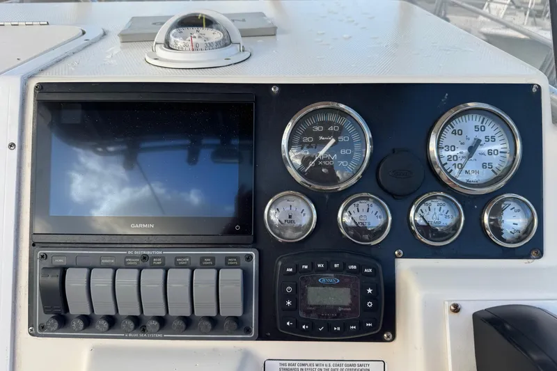 Slide: The Image of Dashboard of a 2001 Sport-Craft 260 Center Console with Garmin display and gauges. - 7
