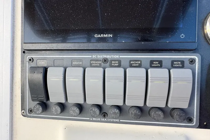 Slide: The Image of Control panel of a 2001 Sport-Craft 260 Center Console boat with labeled switches. - 9