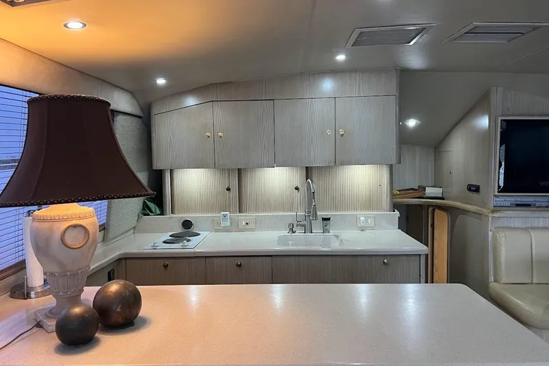 Slide: The Image of Cozy bedroom in 1996 Ocean Yachts 48 Super Sport with bed, cabinets, and TV. - 25