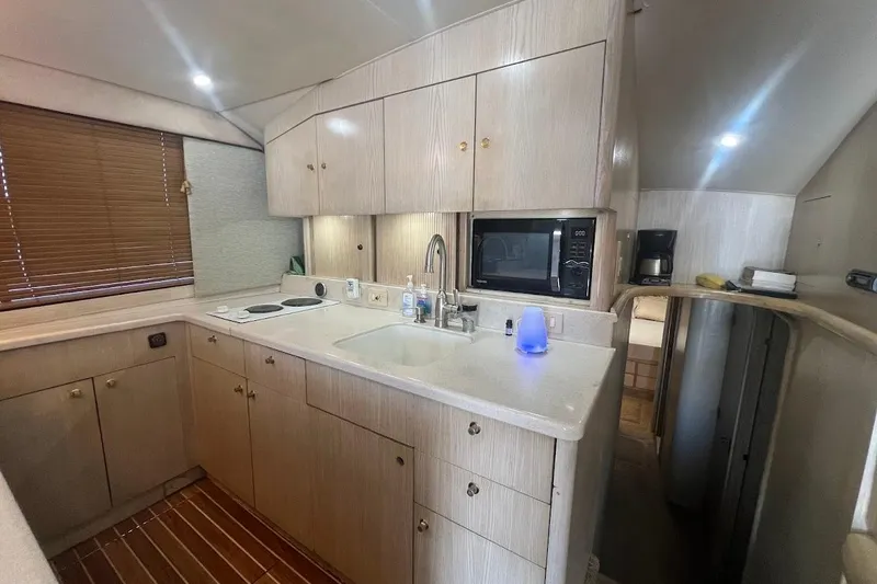 Slide: The Image of 1996 Ocean Yachts 48 Super Sport cabin with bed, artwork, and built-in TV. - 28