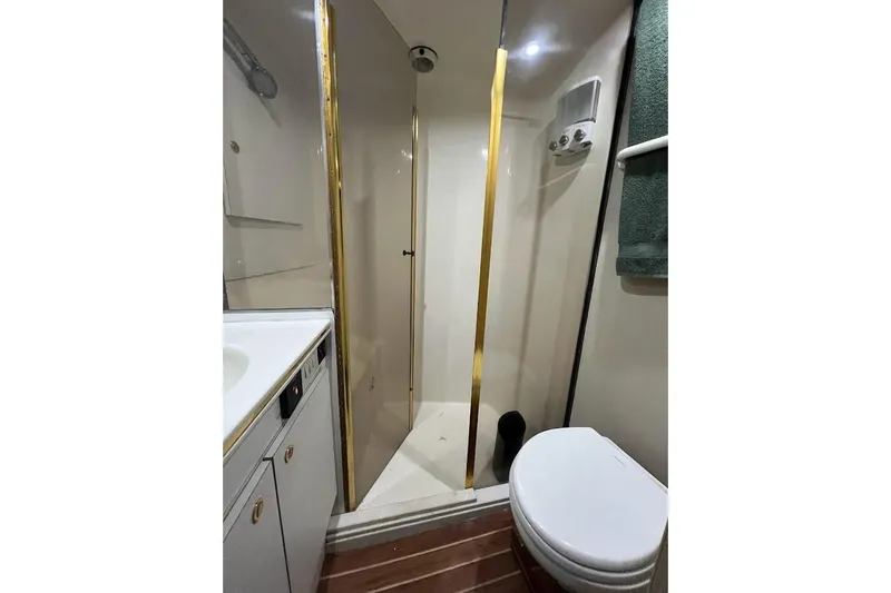 Slide: The Image of Interior of 1996 Ocean Yachts 48 Super Sport, featuring a compact fridge and seating area. - 42