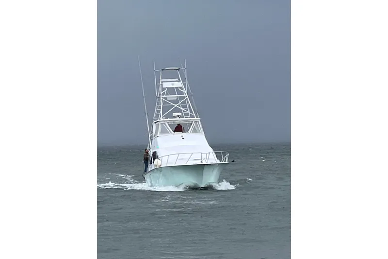 Slide: The Image of 1996 Ocean Yachts 48 Super Sport in a boat lift at a marina. - 58