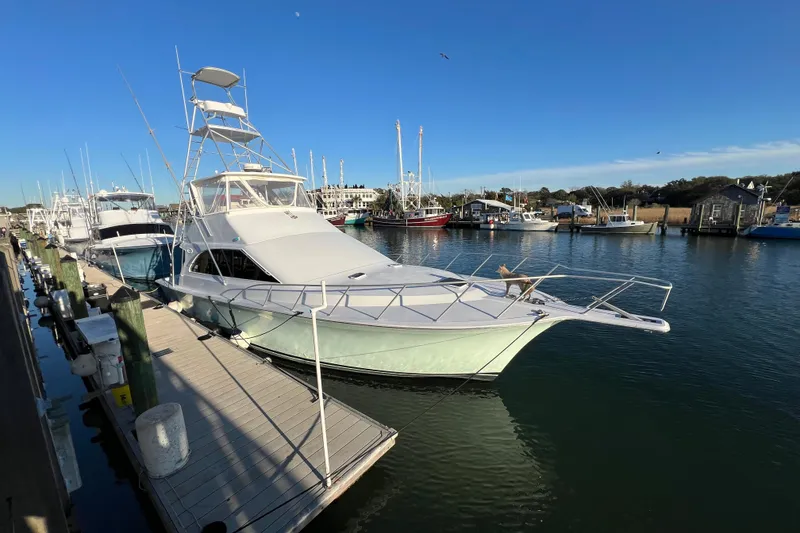 Slide: The Image of 1996 Ocean Yachts 48 Super Sport docked at a marina under clear blue skies. - 62