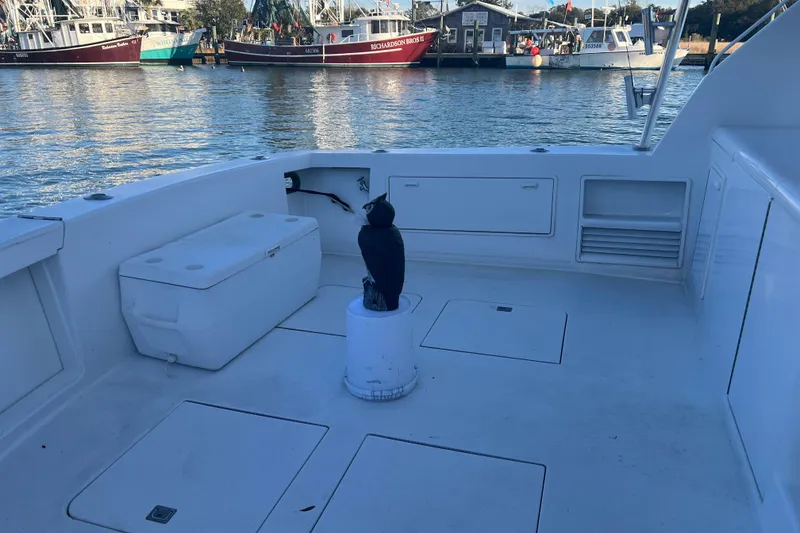 Slide: The Image of 1996 Ocean Yachts 48 Super Sport cruising near construction site in overcast weather. - 64