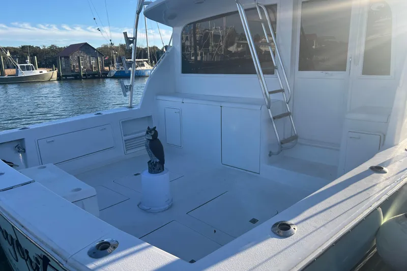 Slide: The Image of 1996 Ocean Yachts 48 Super Sport cruising in a marina, surrounded by other boats. - 65