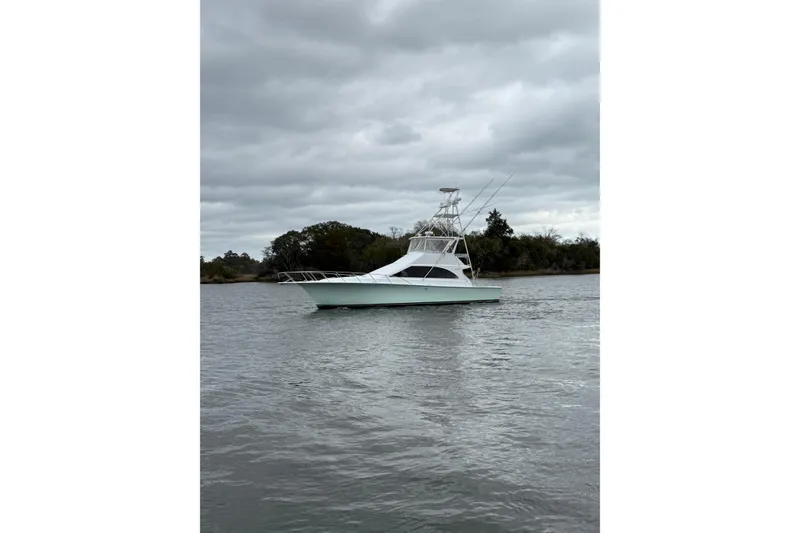 The Image of 1996 Ocean Yachts 48 Super Sport cruising near construction site with excavators. - 0