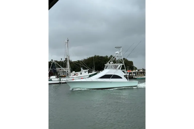 Slide: The Image of 1996 Ocean Yachts 48 Super Sport boat on calm water under cloudy skies. - 53