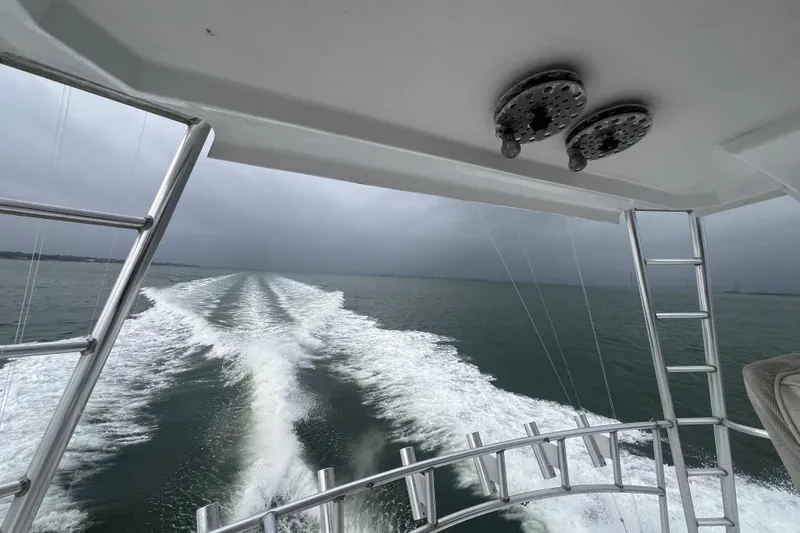 Slide: The Image of Cockpit of 1996 Ocean Yachts 48 Super Sport, featuring storage compartments and a cooler. - 54