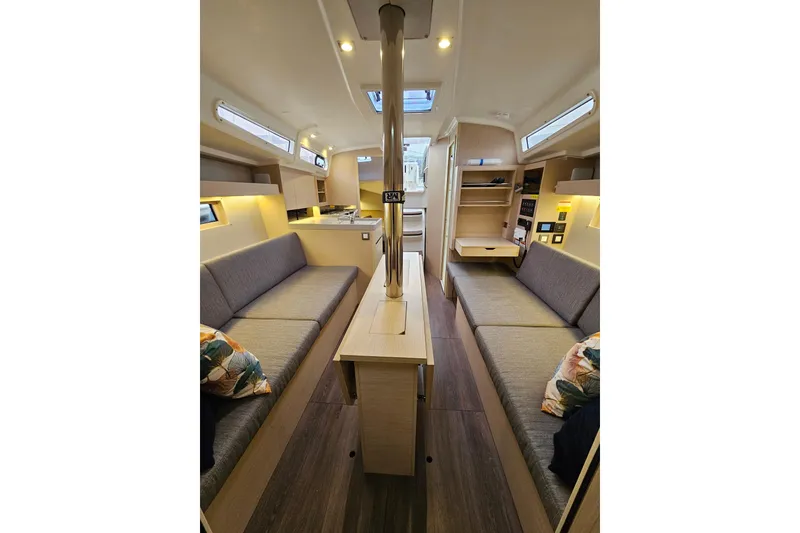 Slide: The Image of 2023 Beneteau Oceanis 34.1 interior with modern seating and wooden finishes. - 12