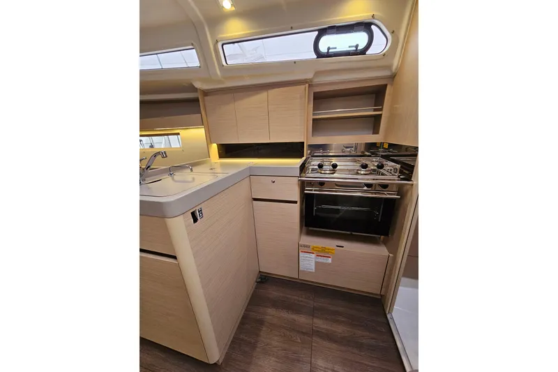 Slide: The Image of 2023 Beneteau Oceanis 34.1 yacht kitchen with modern appliances and sleek cabinetry. - 14