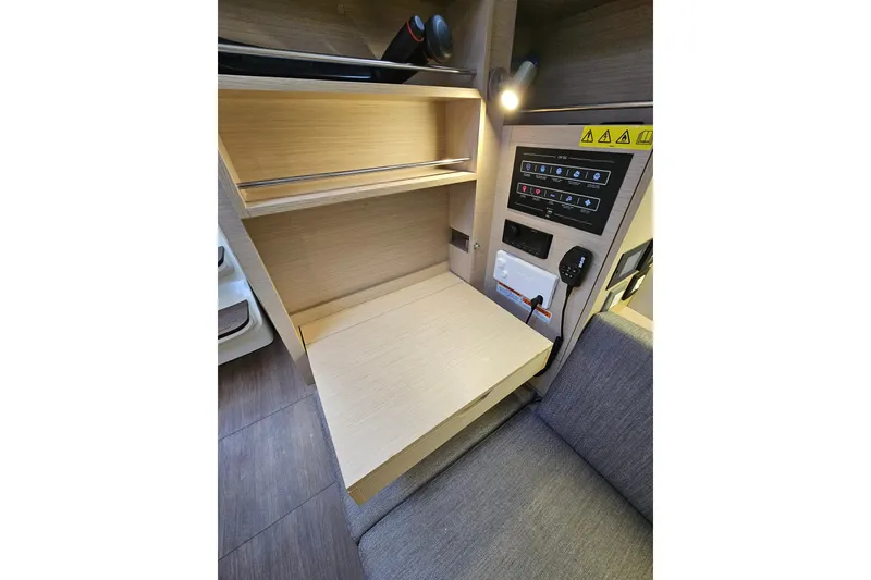 Slide: The Image of 2023 Beneteau Oceanis 34.1 interior with control panel and foldable desk. - 15