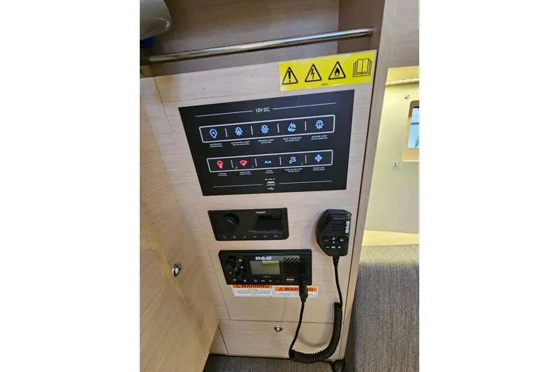 Slide: The Image of Control panel of 2023 Beneteau Oceanis 34.1 yacht, featuring navigation and communication equipment. - 16