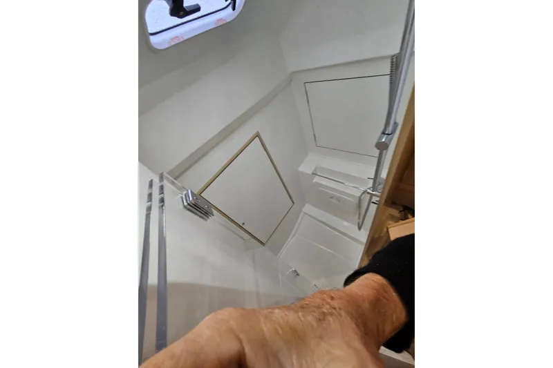 Slide: The Image of Interior view of 2023 Beneteau Oceanis 34.1 yacht bathroom with shower. - 18