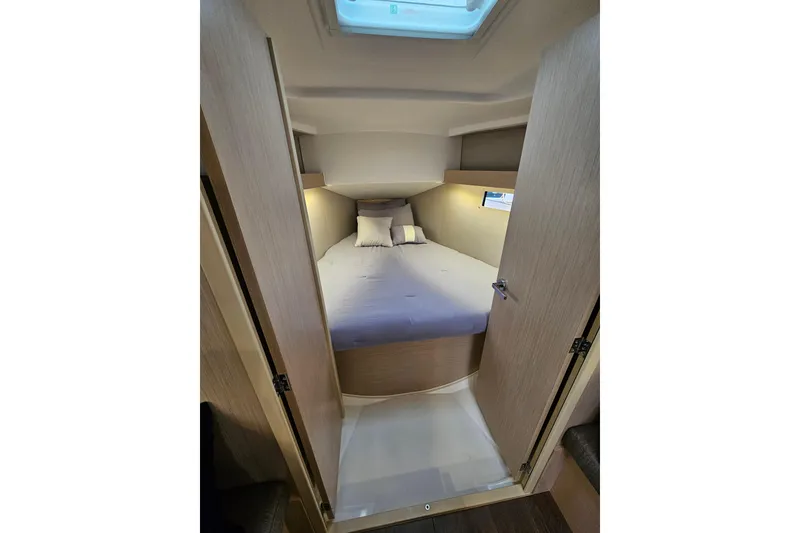 Slide: The Image of Cozy cabin interior of 2023 Beneteau Oceanis 34.1 sailboat with comfortable bedding. - 19