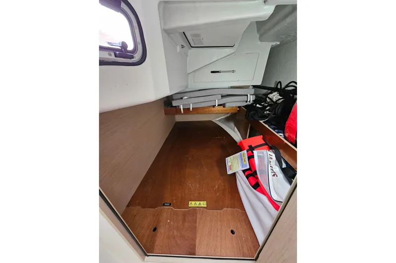 Slide: The Image of Interior storage space of 2023 Beneteau Oceanis 34.1 sailboat, featuring life jackets and equipment. - 23