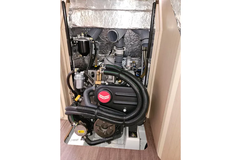 Slide: The Image of 2023 Beneteau Oceanis 34.1 engine compartment with visible components and insulation. - 24