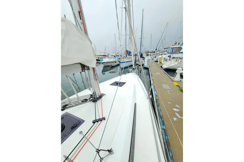 Slide: The Image of 2023 Beneteau Oceanis 34.1 sailboat docked in a marina, showcasing sleek design. - 3