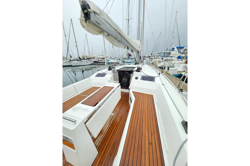 Slide: The Image of 2023 Beneteau Oceanis 34.1 sailboat with teak deck, docked in a marina. - 7