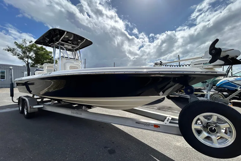 The Image of 2012 ShearWater 25 LTZ boat on trailer under cloudy sky. - 0