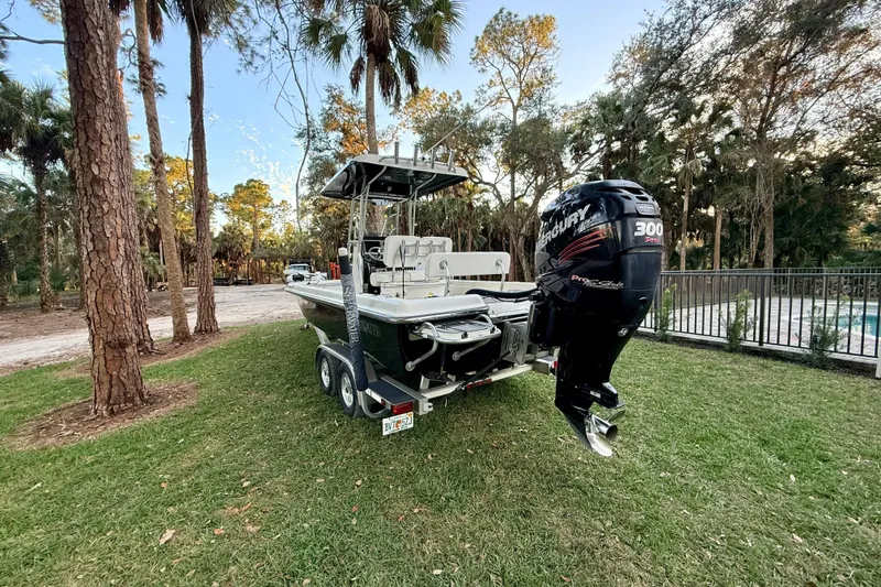 Slide: The Image of 2012 ShearWater 25LTZ boat with Mercury engine on trailer in wooded area. - 13