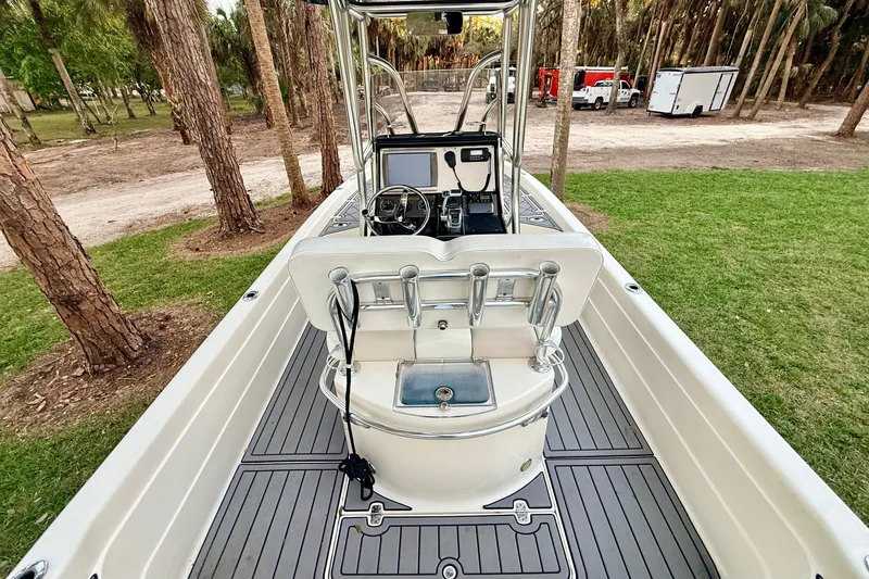 Slide: The Image of 2012 ShearWater 25LTZ boat interior with console, steering wheel, and rod holders. - 20