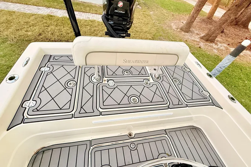 Slide: The Image of 2012 ShearWater 25LTZ boat deck with custom non-slip flooring and motor. - 23