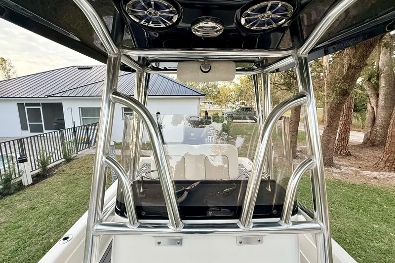 Slide: The Image of 2012 ShearWater 25LTZ boat with sleek metal framework and outdoor background. - 37