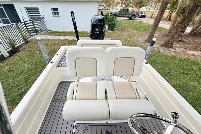 Slide: The Image of 2012 ShearWater 25LTZ boat interior with white seating and steering wheel. - 43