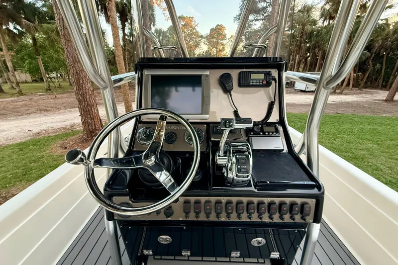 Slide: The Image of 2012 ShearWater 25LTZ boat console with steering wheel and navigation controls. - 45