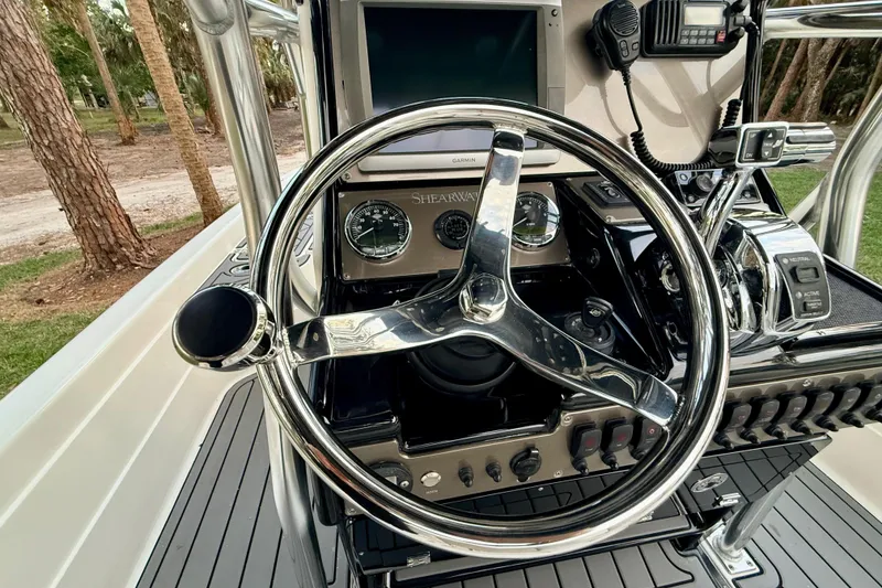 Slide: The Image of Steering console of 2012 ShearWater 25LTZ boat with gauges and controls. - 46