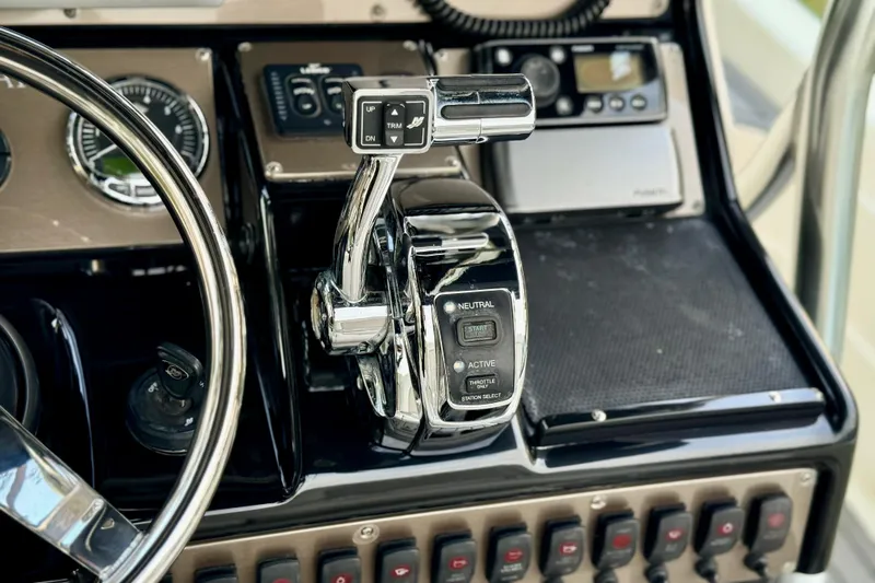 Slide: The Image of Control panel of 2012 ShearWater 25LTZ boat with throttle and switches. - 48