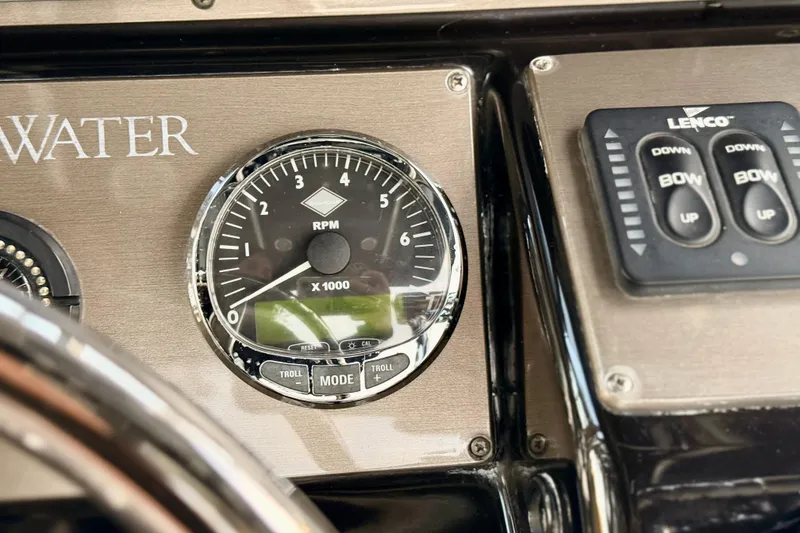 Slide: The Image of Dashboard of 2012 ShearWater 25LTZ boat with RPM gauge and Lenco controls. - 50