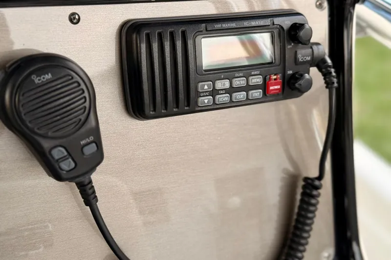 Slide: The Image of VHF marine radio and microphone on 2012 ShearWater 25LTZ boat dashboard. - 52