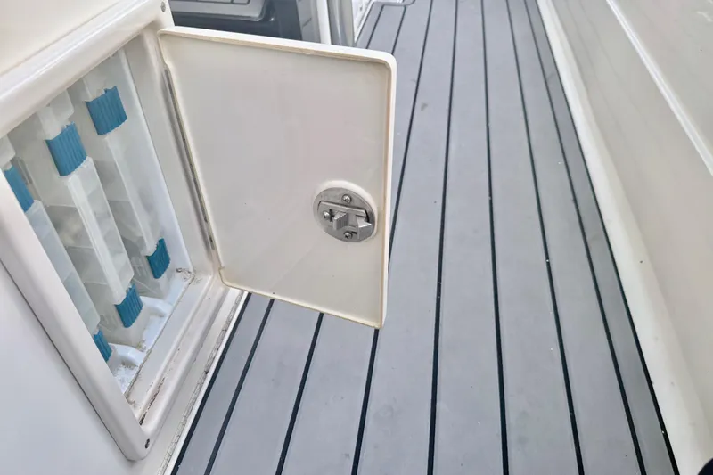 Slide: The Image of Open hatch on 2012 ShearWater 25LTZ boat deck, showing storage compartment. - 57
